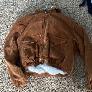 It’s a brown, fluffy jacket. Large in girls.Brand is Ashley By 26 International.